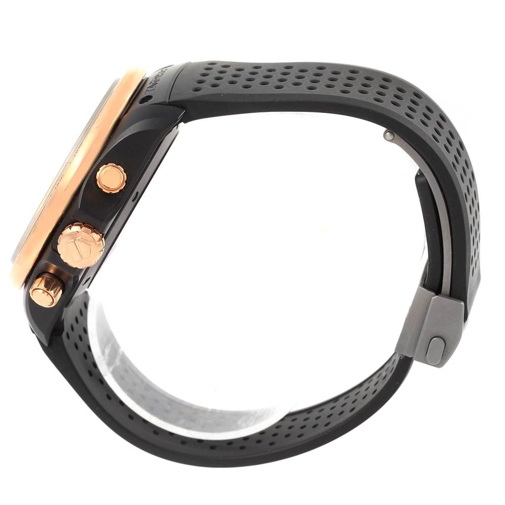 The image shows a side view of the Tag Heuer Carrera CAV518E.FT6016 Men's Rose Gold Black Dial CAV518E.FT6016 Men's Rose Gold Black Dial watch, highlighting the crown, pushers, and perforated strap.