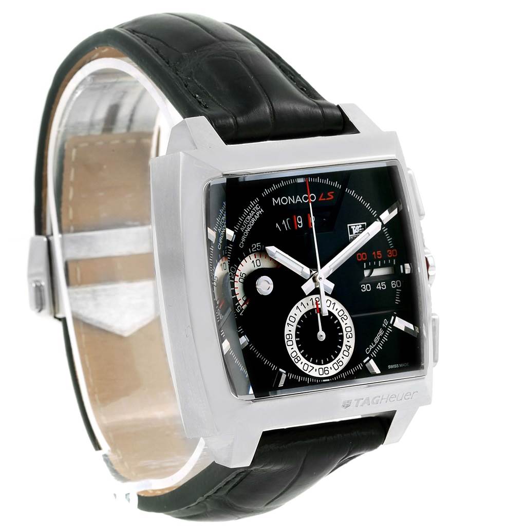 The image shows a Tag Heuer Monaco CAL2110.FC6257 Men's Stainless Steel Black Dial CAL2110.FC6257 Men's Stainless Steel Black Dial watch at an angle, highlighting its square case, black dial, chronograph functions, and leather strap.