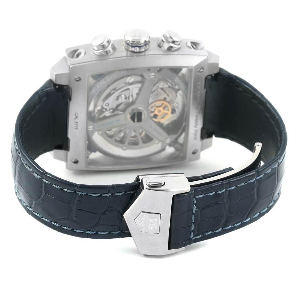 The image shows the back view of a Tag Heuer Monaco CAL5111.FC6299 Men's Stainless Steel Blue Dial CAL5111.FC6299 Men's Stainless Steel Blue Dial watch, highlighting its transparent case back, strap, and clasp.
