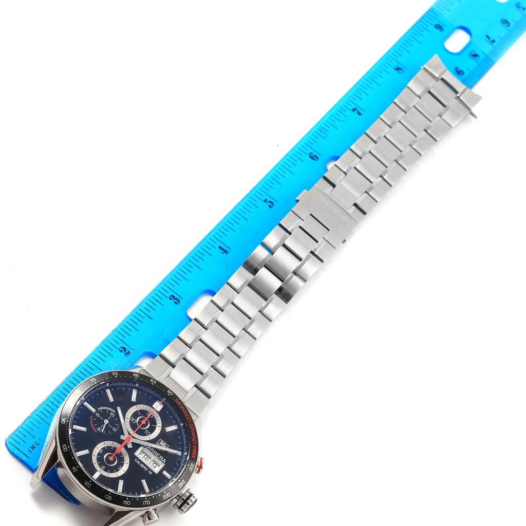 The image shows a Tag Heuer Monaco CV2A1F.BA0796 Men's Stainless Steel Black Dial CV2A1F.BA0796 Men's Stainless Steel Black Dial model watch face and metal band at a top-down angle next to a blue ruler.