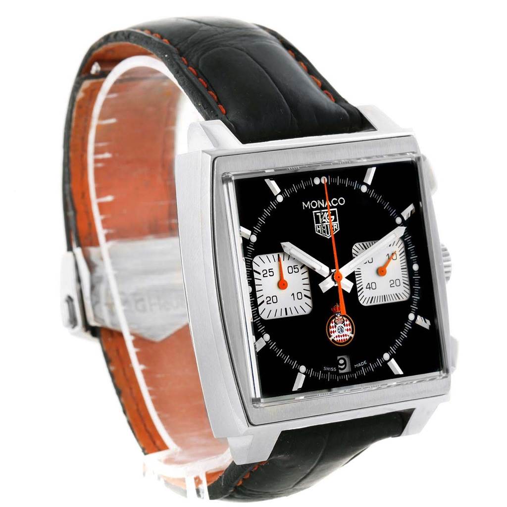 The image shows a Tag Heuer Monaco Limited Edition watch at an angle displaying its square dial, black leather strap, and chronograph subdials.