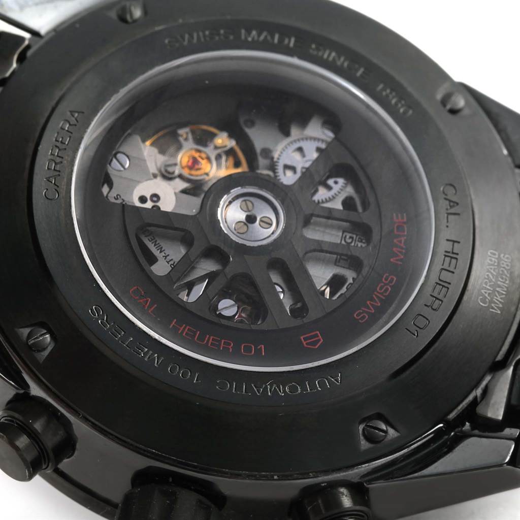 The image shows the back view of a Carrera model Tag Heuer watch, highlighting its automatic movement and internal mechanics.