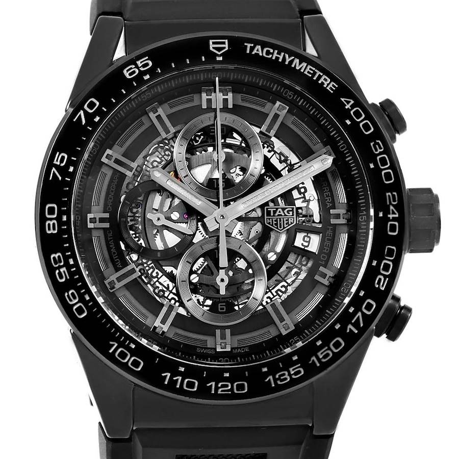 The image shows a frontal view of the Tag Heuer Carrera watch, highlighting its skeleton dial, tachymeter bezel, and chronograph functions.