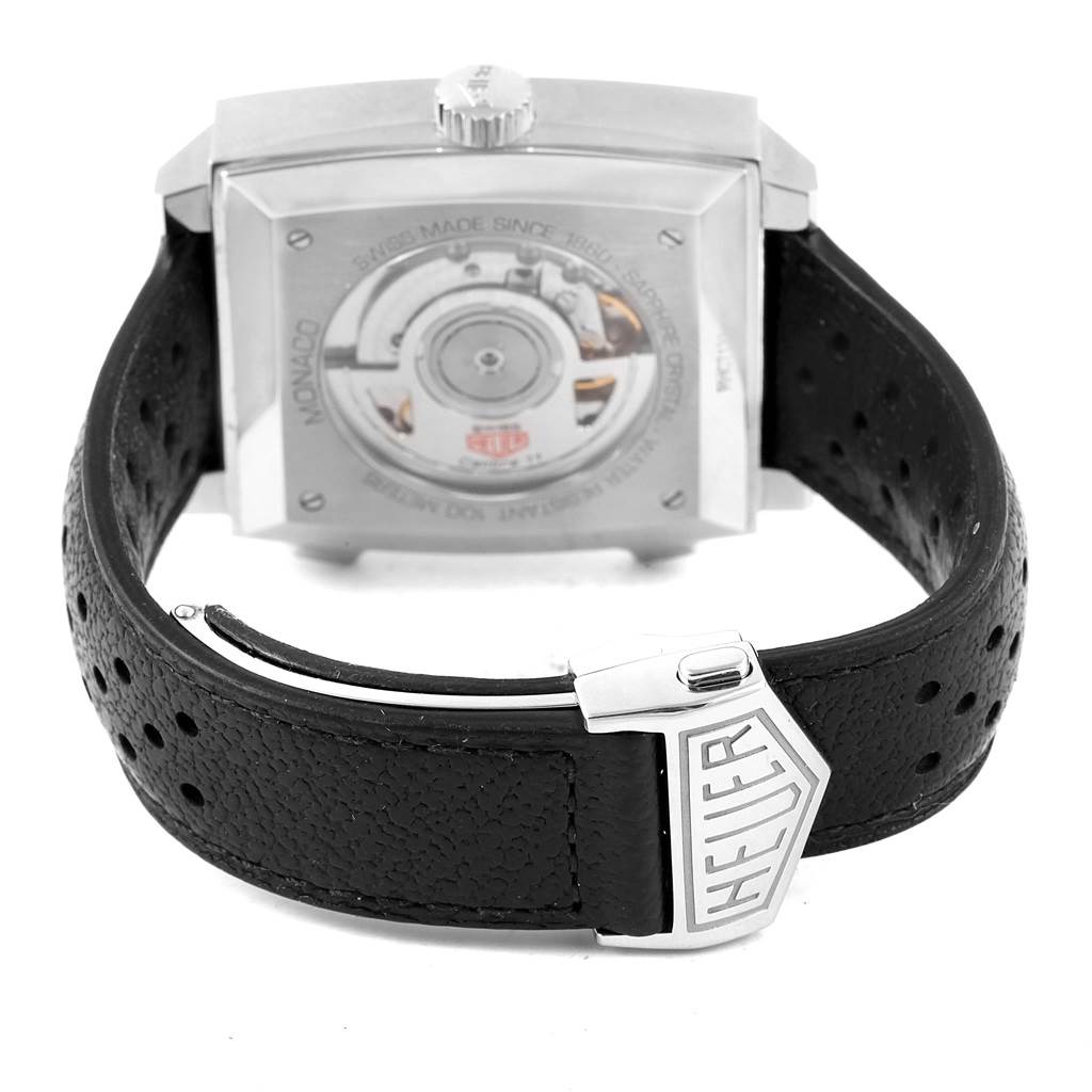 The image shows the back view of a Tag Heuer Monaco CAW211P Men's Stainless Steel Blue Dial CAW211P Men's Stainless Steel Blue Dial watch, showcasing the transparent case back and black leather strap with the Heuer clasp.