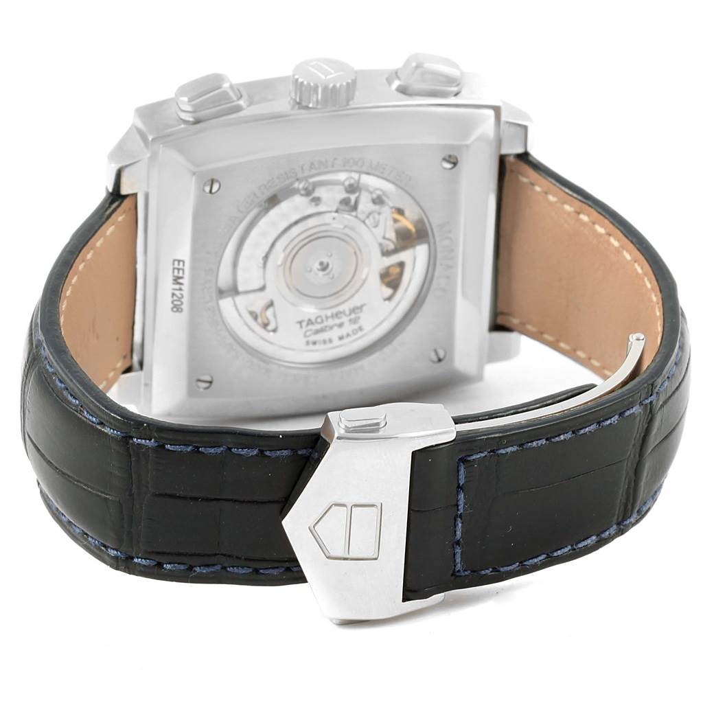 The image shows the back of a Tag Heuer Monaco CAW2111 Men's Stainless Steel Blue Dial CAW2111 Men's Stainless Steel Blue Dial watch, along with its black leather strap and clasp.