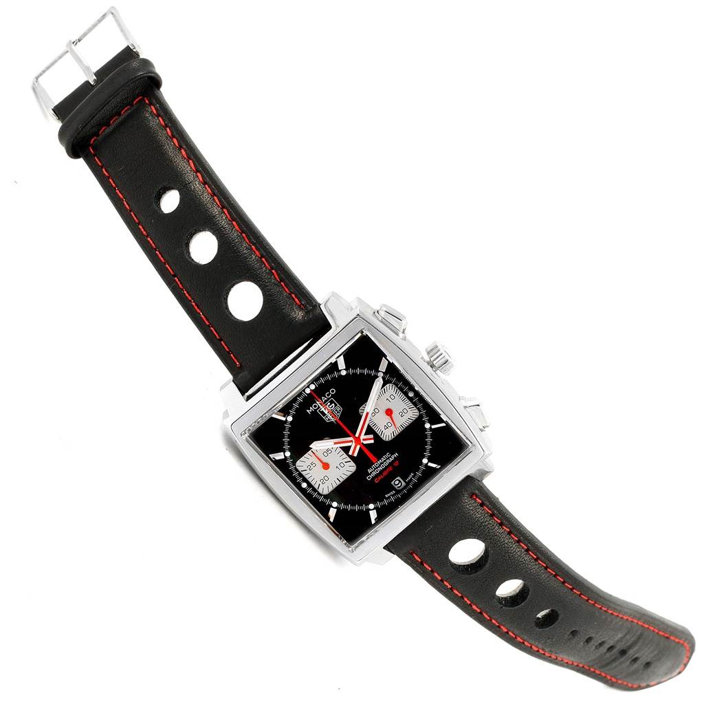 The Tag Heuer Monaco CAW2114 Men's Stainless Steel Black Dial CAW2114 Men's Stainless Steel Black Dial watch is shown from a top-down angle, displaying its square face and black leather strap with red stitching.