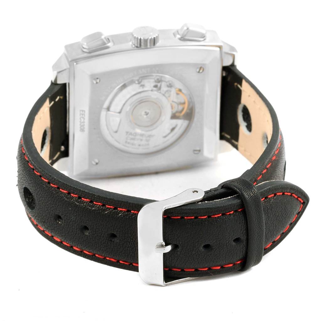The image shows the back view of the Tag Heuer Monaco CAW2114 Men's Stainless Steel Black Dial CAW2114 Men's Stainless Steel Black Dial watch, highlighting the movement and the leather strap with red stitching.