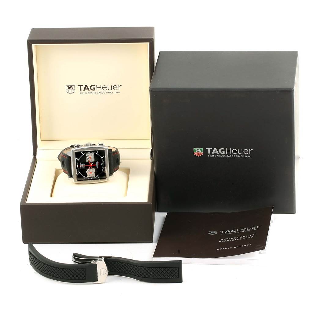 The Tag Heuer Monaco CAW2114 Men's Stainless Steel Black Dial CAW2114 Men's Stainless Steel Black Dial watch is shown at a front angle, featuring its box, an extra strap, and the instruction manual.