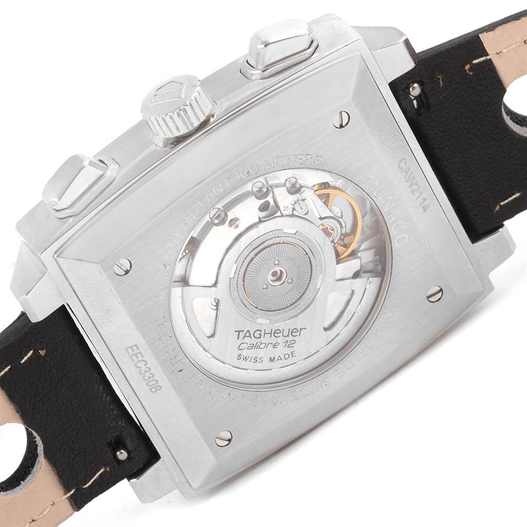 The image shows the back of the Tag Heuer Monaco CAW2114 Men's Stainless Steel Black Dial CAW2114 Men's Stainless Steel Black Dial watch, featuring its internal mechanism and leather strap.