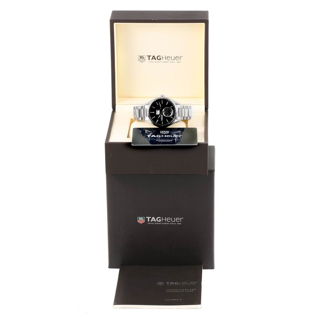 The image shows a Tag Heuer Carrera WAR5010.BA0723 Men
s Stainless Steel Black Dial WAR5010.BA0723 Men
s Stainless Steel Black Dial watch front-on, in its box, along with the warranty card and manual.