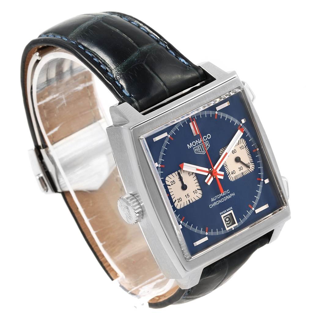 The image shows a Tag Heuer Monaco CAW211A.EB0026 Men's Stainless Steel Blue Dial CAW211A.EB0026 Men's Stainless Steel Blue Dial watch at a 3/4 angle highlighting its square face, leather strap, crown, and chronograph sub-dials.