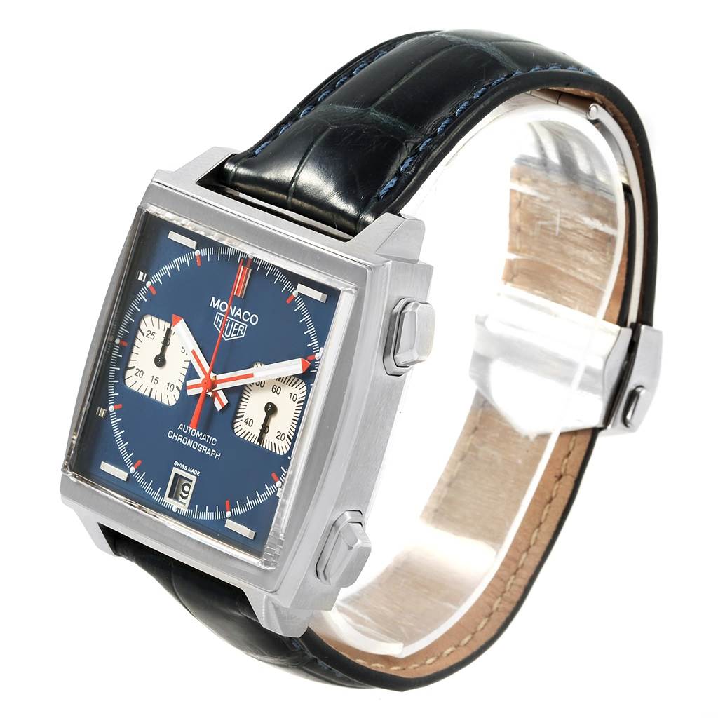 The image shows a Tag Heuer Monaco CAW211A.EB0026 Men's Stainless Steel Blue Dial CAW211A.EB0026 Men's Stainless Steel Blue Dial model watch at a three-quarter angle, highlighting its square face, two subdials, and leather strap.