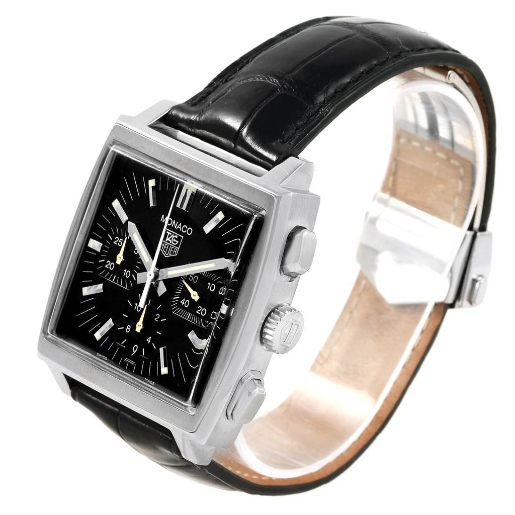 The image shows the Tag Heuer Monaco CW2111 Men's Stainless Steel Black Dial CW2111 Men's Stainless Steel Black Dial watch at an angle highlighting its face, side buttons, and black strap.