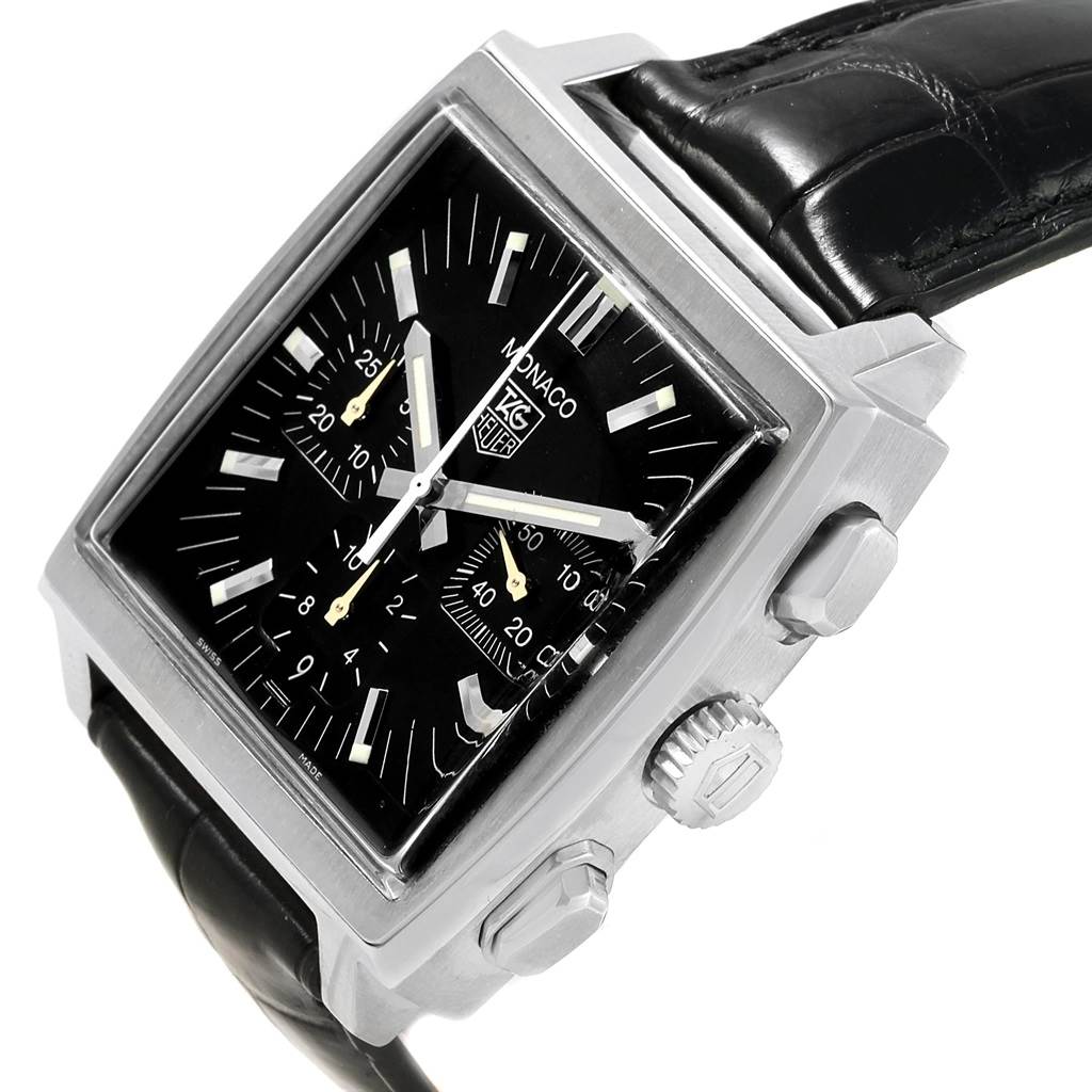 The image shows a Tag Heuer Monaco CW2111 Men's Stainless Steel Black Dial CW2111 Men's Stainless Steel Black Dial watch from a slightly tilted angle, highlighting its square dial, crown, pushers, and black strap.
