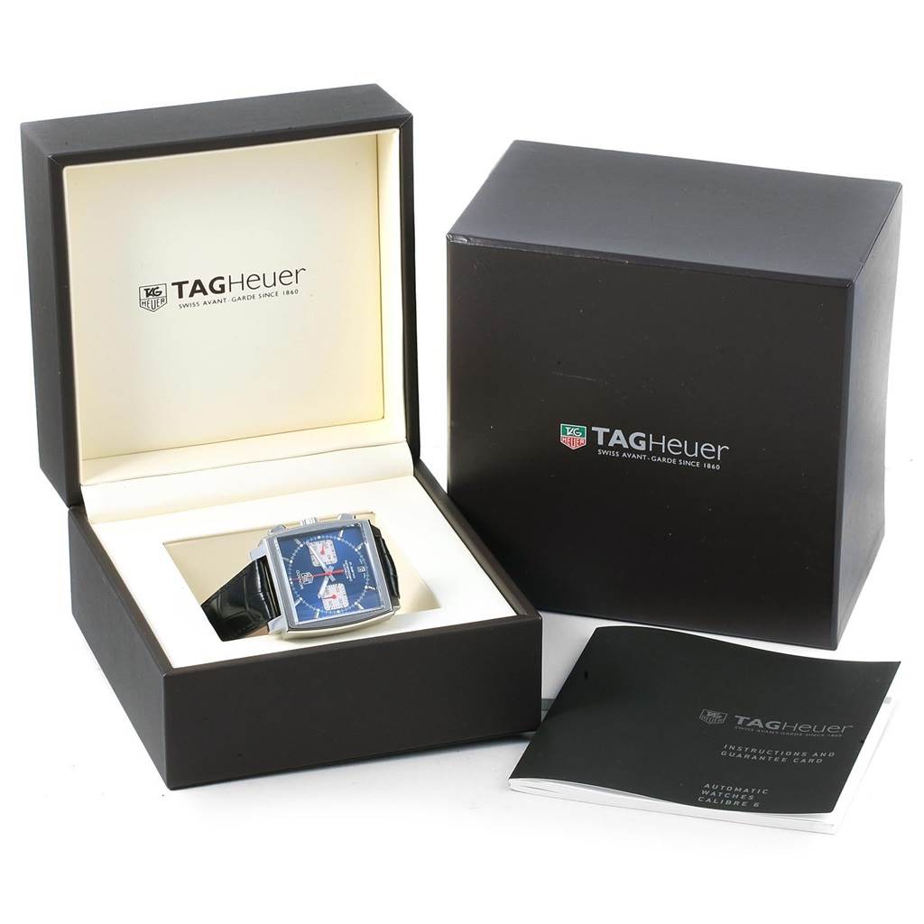 The image shows a Tag Heuer Monaco CAW2111 Men
s Stainless Steel Blue Dial CAW2111 Men
s Stainless Steel Blue Dial watch inside its open box, with a closed box and a booklet next to it.