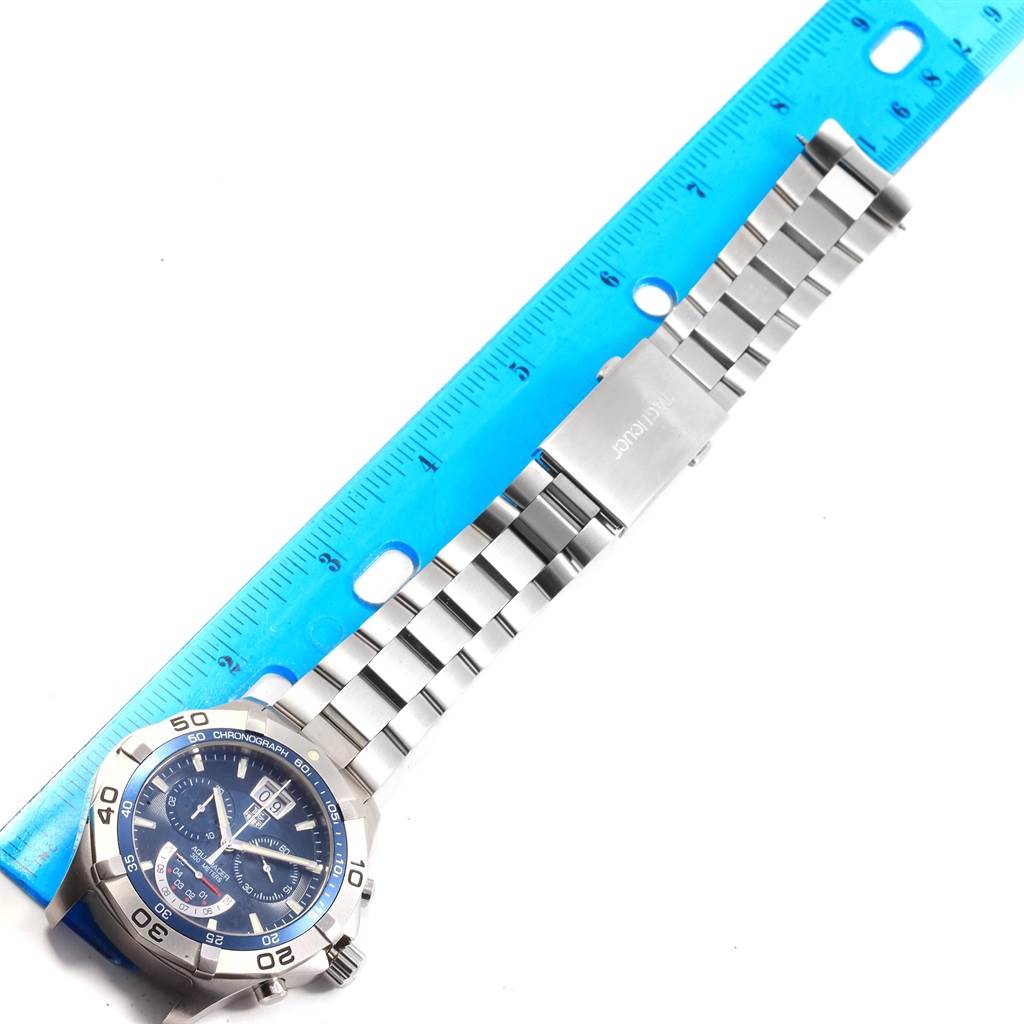 The image shows a Tag Heuer Aquaracer CAF101C.BA0821 Men's Stainless Steel Blue Dial CAF101C.BA0821 Men's Stainless Steel Blue Dial watch laid flat with a blue ruler next to it for scale.