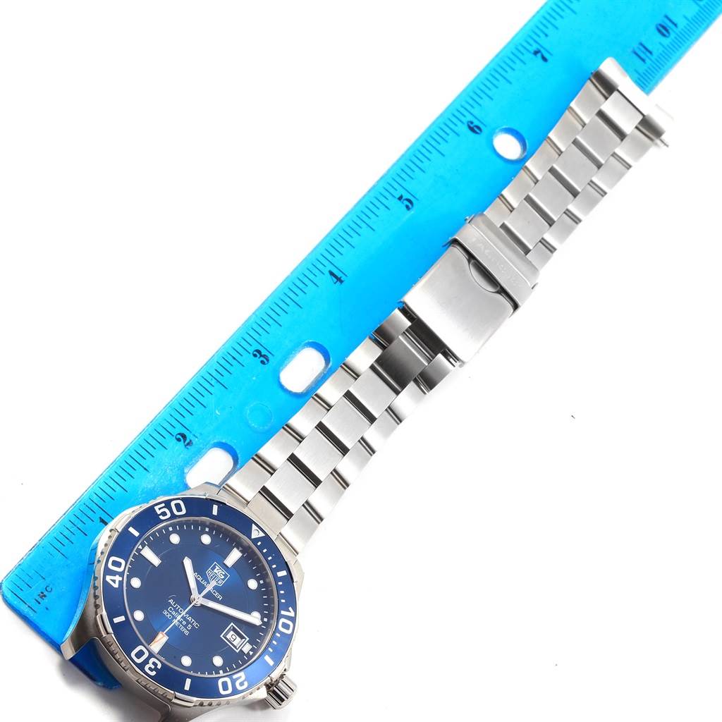 This image shows a Tag Heuer Aquaracer WAN2111.BA0822 Men
s Stainless Steel Blue Dial WAN2111.BA0822 Men
s Stainless Steel Blue Dial watch laid flat with a blue ruler measuring its stainless steel bracelet.