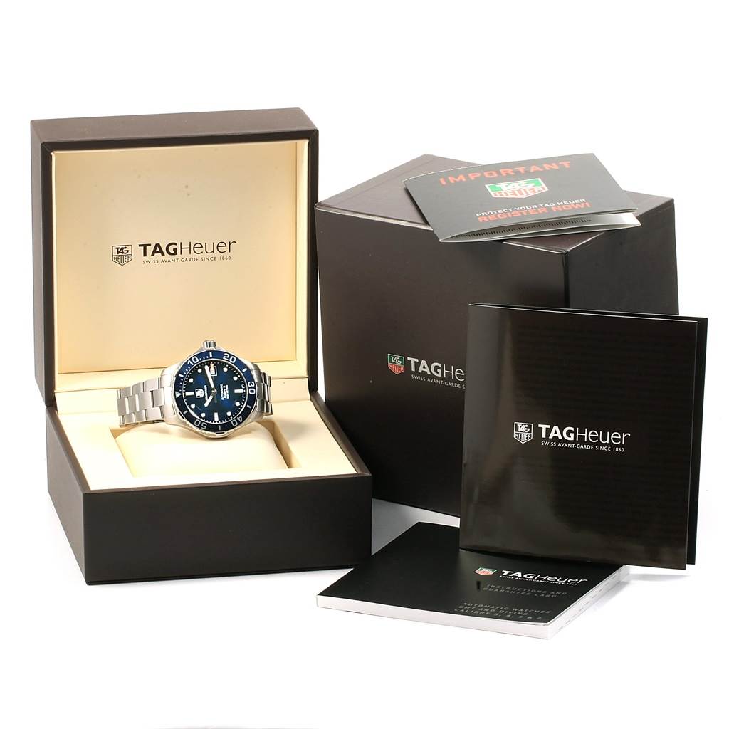 The image shows a Tag Heuer Aquaracer WAN2111.BA0822 Men
s Stainless Steel Blue Dial WAN2111.BA0822 Men
s Stainless Steel Blue Dial watch at an angle with its packaging and accompanying booklets.