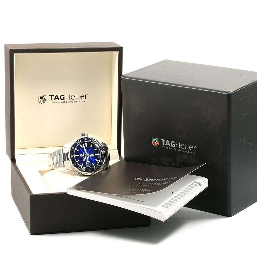 The image shows the Tag Heuer Limited Edition WAJ2116.BA0870 Men's Stainless Steel Blue Dial WAJ2116.BA0870 Men's Stainless Steel Blue Dial watch from a front angle, including its box and accompanying booklet.