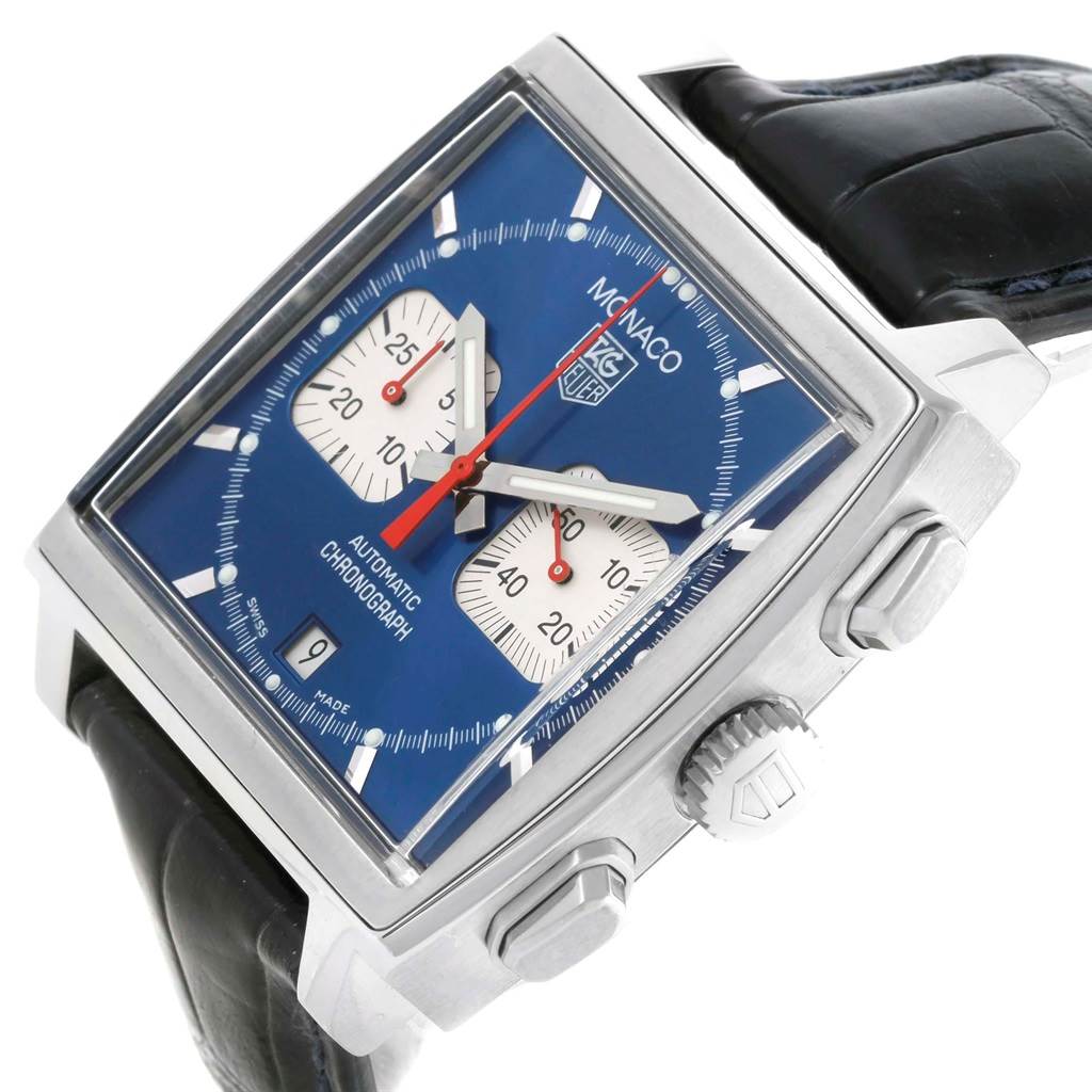 This image shows a Tag Heuer Monaco TAG HEUER Men's Stainless Steel Blue Dial TAG HEUER Men's Stainless Steel Blue Dial watch at a slight angle, highlighting its square face, blue dial, and chronograph subdials.