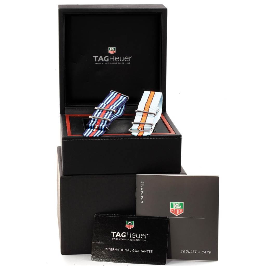 This image shows various accessories for the Tag Heuer Monaco CAW2111 Men
s Stainless Steel Blue Dial CAW2111 Men
s Stainless Steel Blue Dial model, including watch straps, guarantee card, and booklet, all presented in a box.