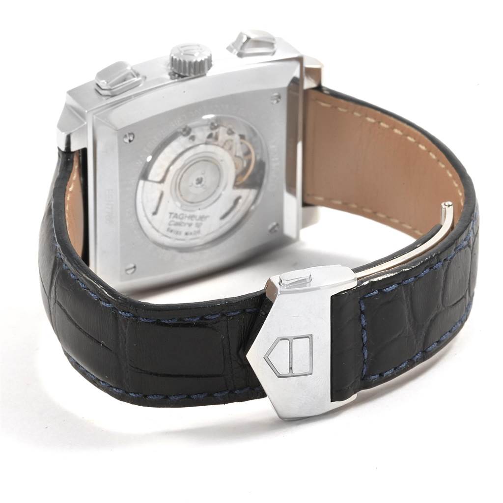 Shown from the back, this Tag Heuer Monaco CAW2111 Men
s Stainless Steel Blue Dial CAW2111 Men
s Stainless Steel Blue Dial watch reveals the transparent case back and part of the black leather strap with blue stitching.