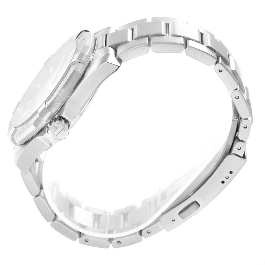 The Aquaracer by Tag Heuer is shown in a side view, highlighting the case, crown, and metal bracelet.