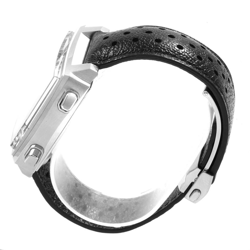 The image shows a side view of the Tag Heuer Monaco CAW211P Men's Stainless Steel Blue Dial CAW211P Men's Stainless Steel Blue Dial watch, showcasing the crown, pushers, and perforated black leather strap.