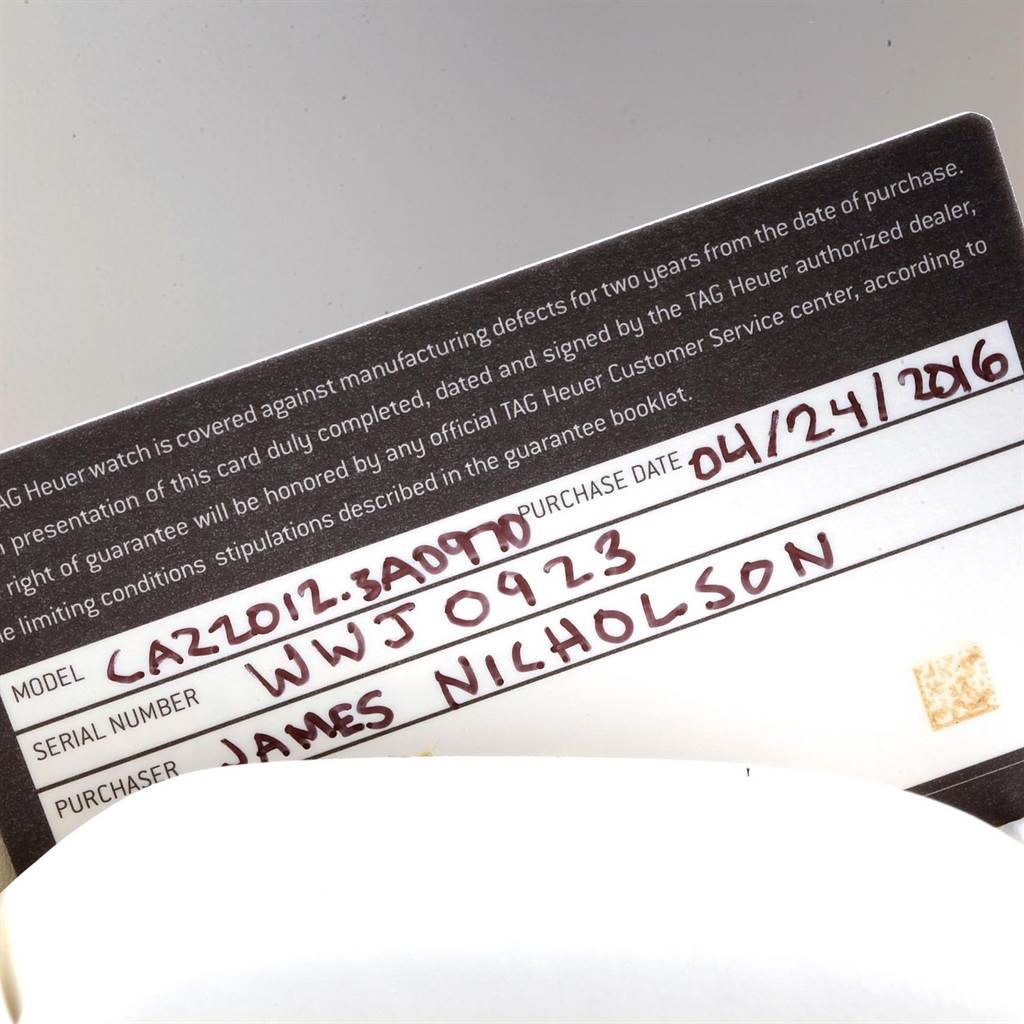 This image shows the warranty card for the Tag Heuer Formula 1 CAZ2012.BA0970 Men's Stainless Steel Grey Dial CAZ2012.BA0970 Men's Stainless Steel Grey Dial watch, with model and serial numbers handwritten.