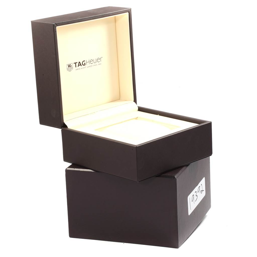 The image shows an open Tag Heuer Monaco CAW2111 Men's Stainless Steel Blue Dial CAW2111 Men's Stainless Steel Blue Dial watch box from a slightly elevated angle, revealing the interior and exterior.