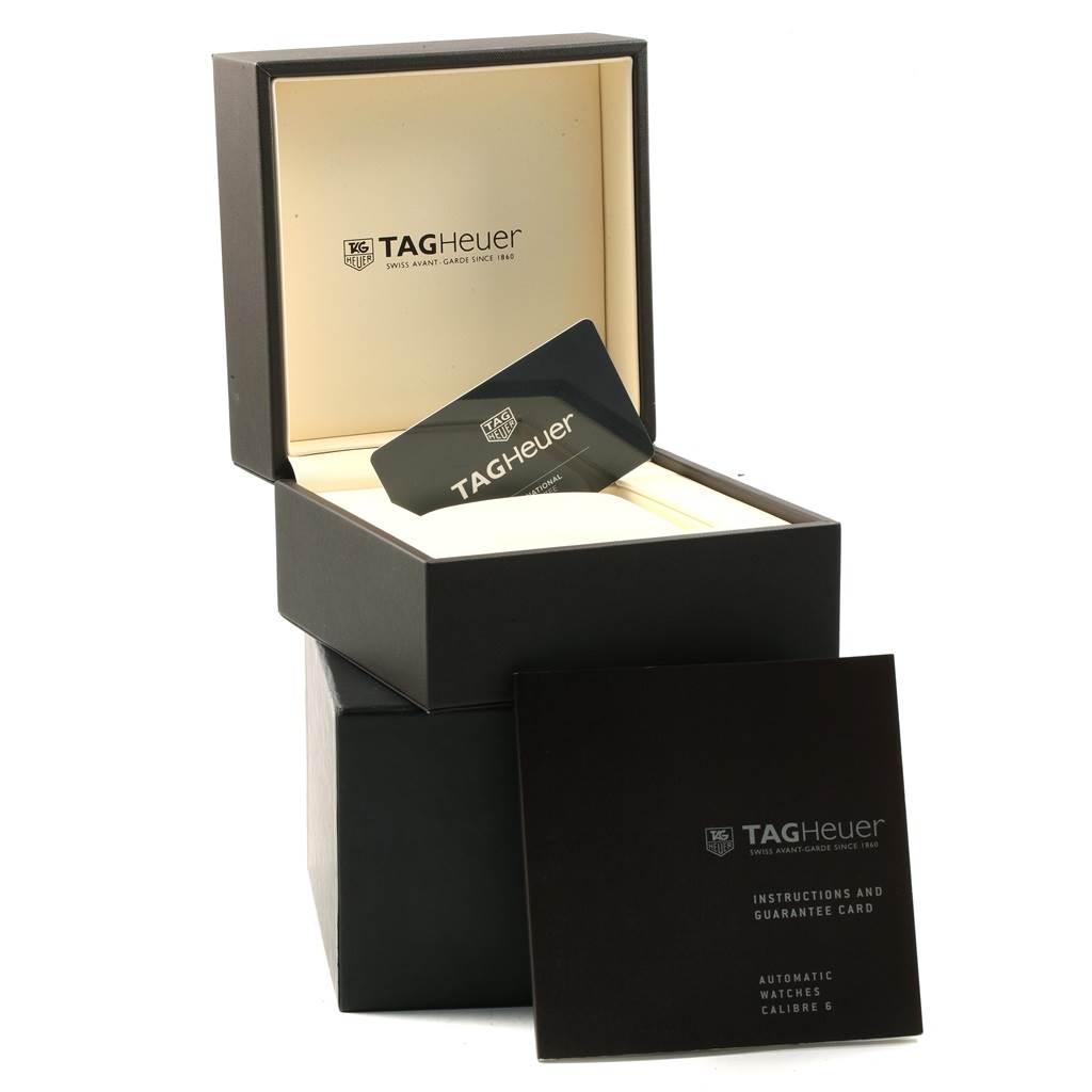 The image shows the Tag Heuer Monaco CAW211M.FC6324 Men's Titanium Black Dial CAW211M.FC6324 Men's Titanium Black Dial watch box, warranty card, and instruction manual from a slightly elevated angle.