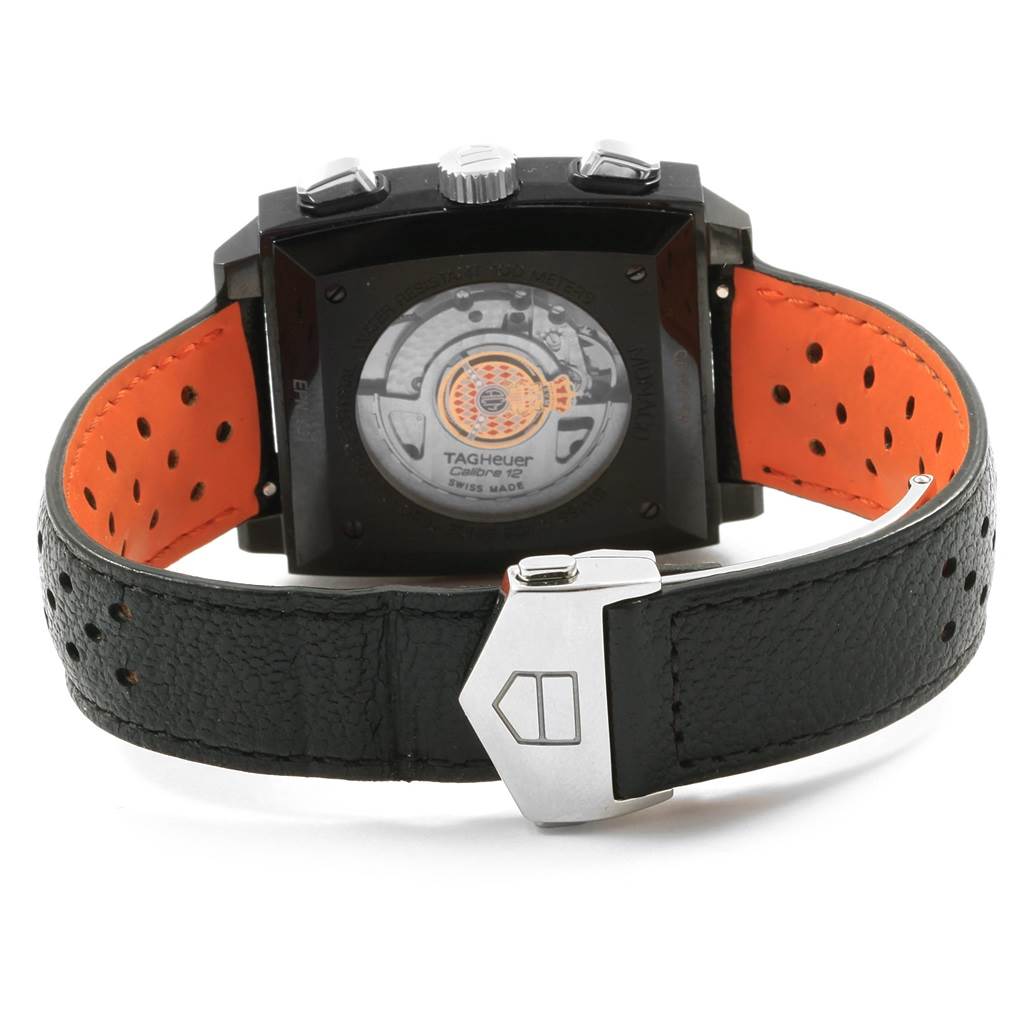 The image shows the back view of a Tag Heuer Monaco CAW211M.FC6324 Men's Titanium Black Dial CAW211M.FC6324 Men's Titanium Black Dial watch, highlighting its movement and perforated strap.