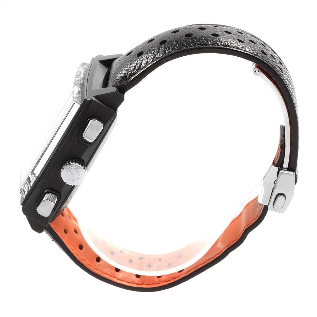 The image shows a side view of the Tag Heuer Monaco CAW211M.FC6324 Men's Titanium Black Dial CAW211M.FC6324 Men's Titanium Black Dial watch, displaying its crown, pushers, and perforated black strap with orange lining.
