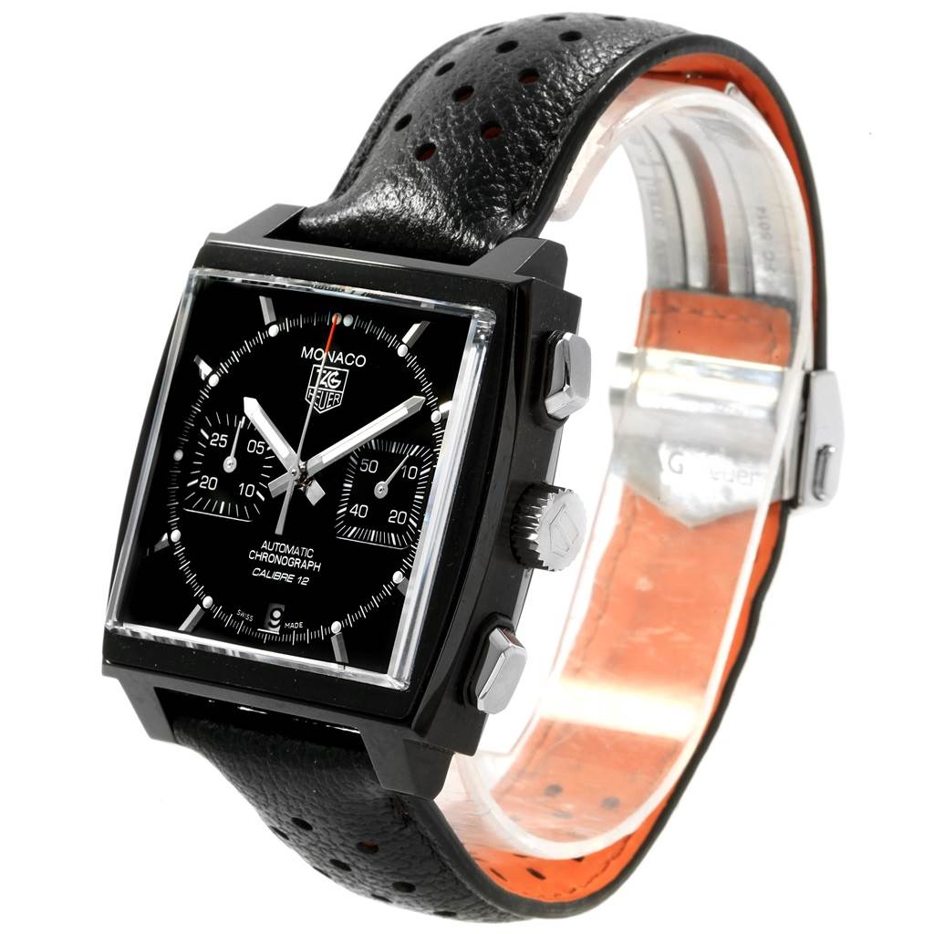 The image shows a Tag Heuer Monaco CAW211M.FC6324 Men's Titanium Black Dial CAW211M.FC6324 Men's Titanium Black Dial watch from a three-quarter angle, displaying its face, bezel, crown, and perforated leather strap.