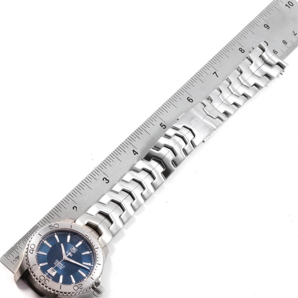 The image shows a Tag Heuer Link WJ201C.BA0591 Men's Stainless Steel Blue Dial WJ201C.BA0591 Men's Stainless Steel Blue Dial model watch laid flat, displaying the face and band next to a ruler for scale.