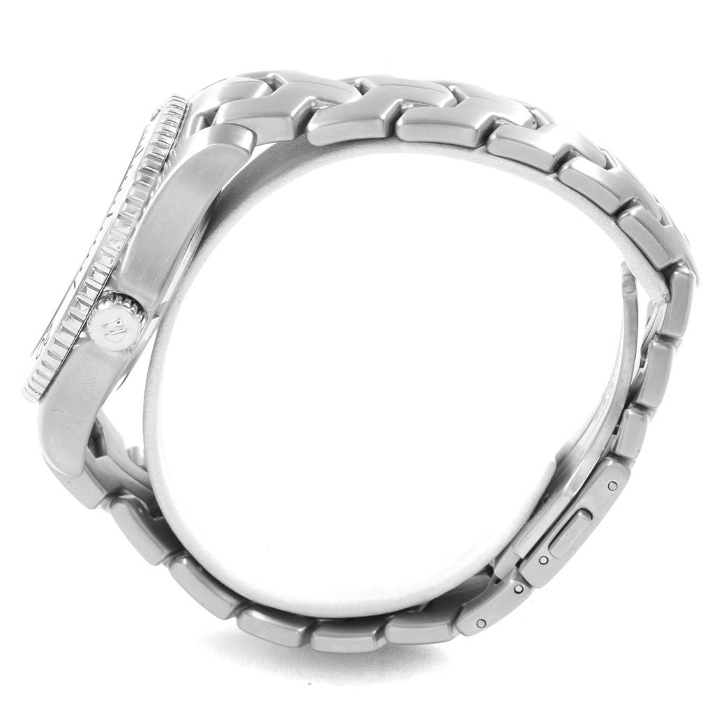 The image shows a side view of a Tag Heuer Link WJ201C.BA0591 Men's Stainless Steel Blue Dial WJ201C.BA0591 Men's Stainless Steel Blue Dial model watch, highlighting its case, crown, and bracelet.