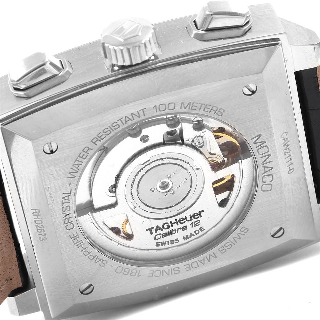 This image shows the case back of a Tag Heuer Monaco CAW2111 Men's Stainless Steel Blue Dial CAW2111 Men's Stainless Steel Blue Dial watch, displaying the movement mechanism and accompanying engravings.