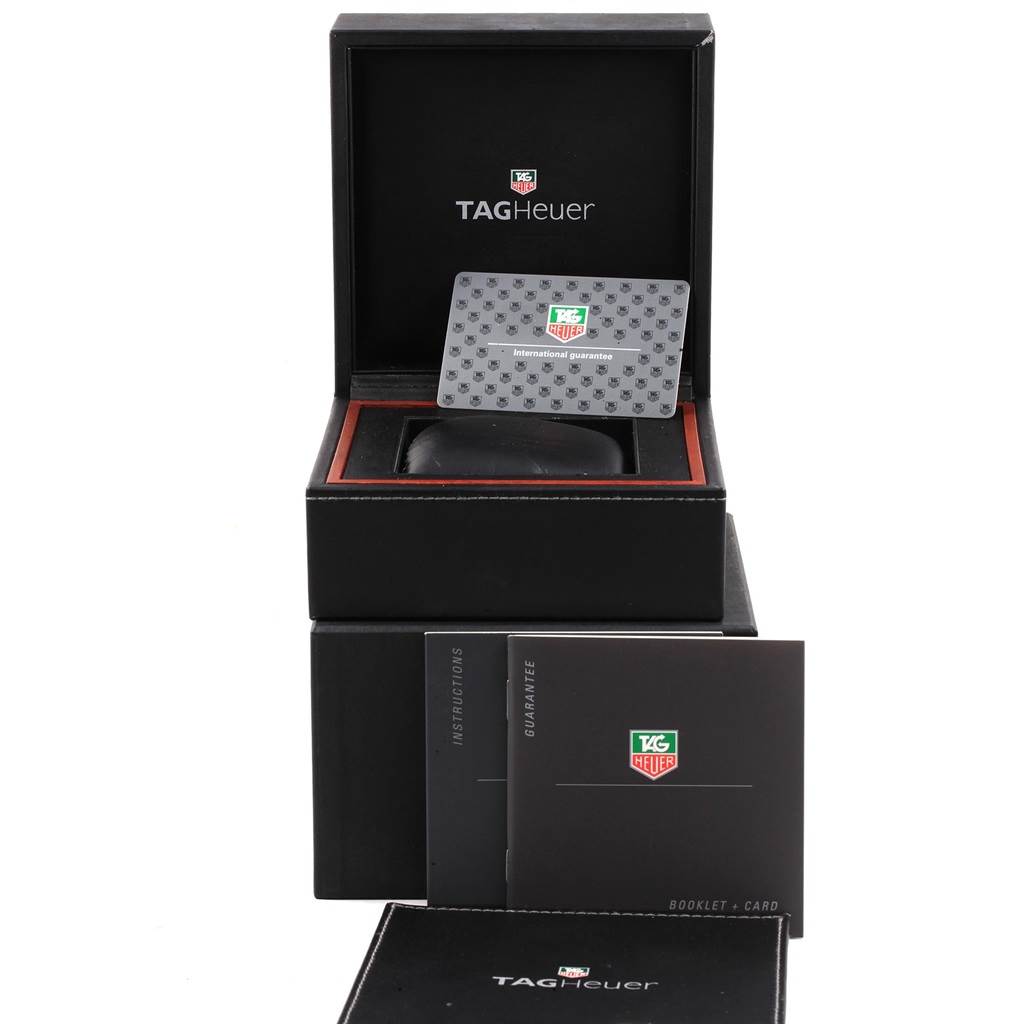 The image shows the packaging and accessories for a Limited Edition TAG Heuer watch, including a box, booklet, and guarantee card.