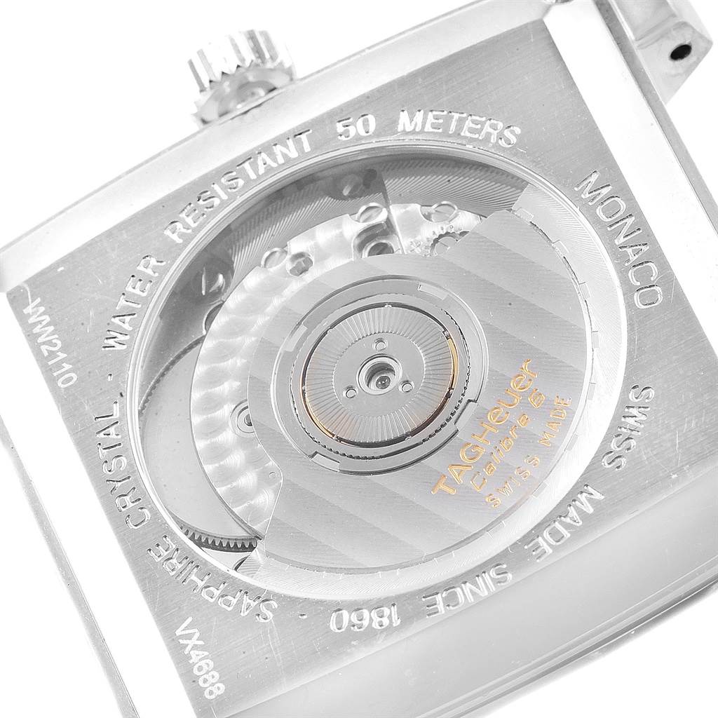 The image shows the back view of a Tag Heuer Monaco WW2110 Men's Stainless Steel Black Dial WW2110 Men's Stainless Steel Black Dial watch, highlighting the movement and engraving details.