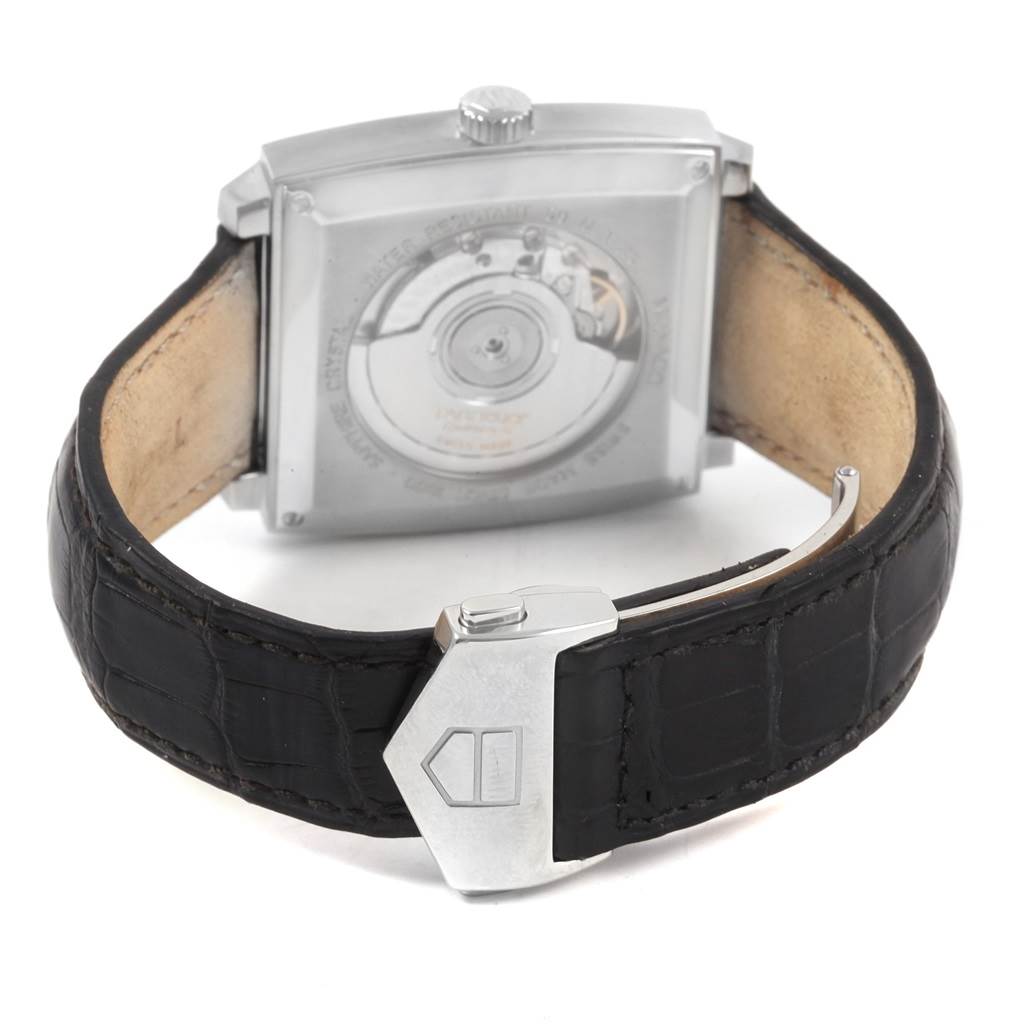 The image shows the back angle of the Tag Heuer Monaco WW2110 Men's Stainless Steel Black Dial WW2110 Men's Stainless Steel Black Dial watch, featuring its case, crown, movement, and black leather strap.