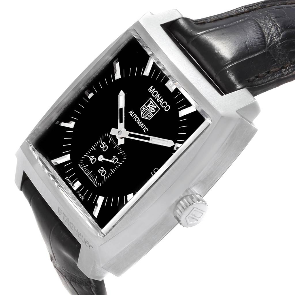 The image shows a Tag Heuer Monaco WW2110 Men's Stainless Steel Black Dial WW2110 Men's Stainless Steel Black Dial model watch at an angled side view, highlighting its square dial, strap, and crown.
