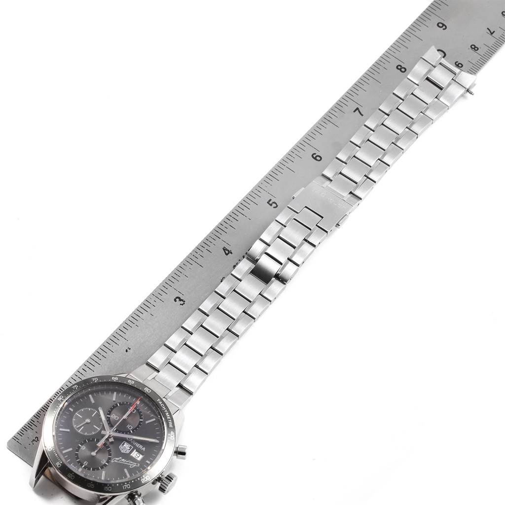 The image shows a top-down view of a Tag Heuer Limited Edition CV201C.BA0786 Men's Stainless Steel Black Dial CV201C.BA0786 Men's Stainless Steel Black Dial watch, highlighting its face and metal bracelet alongside a ruler for scale.