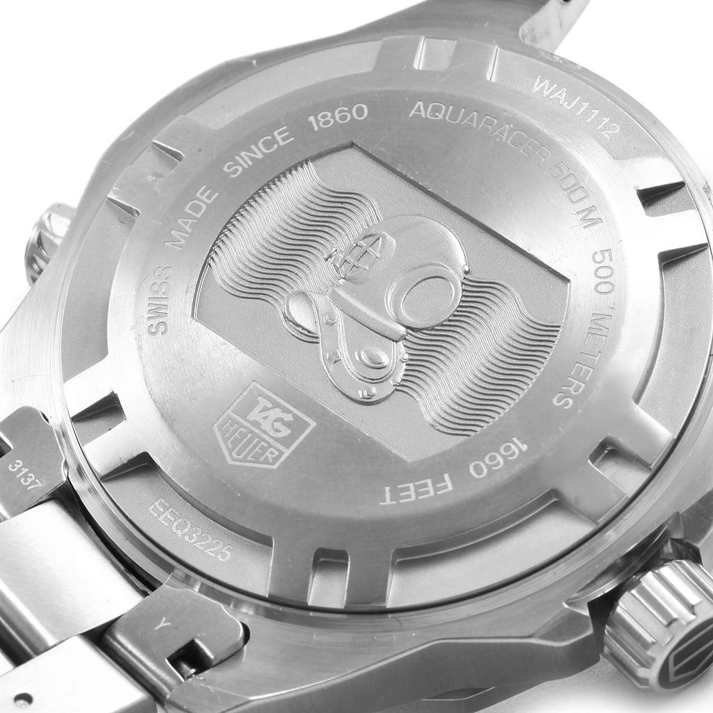 The image shows the back of a Tag Heuer Aquaracer WAJ1112.BA0871 Men's Stainless Steel Blue Dial WAJ1112.BA0871 Men's Stainless Steel Blue Dial watch with engravings and the clasp partially visible.