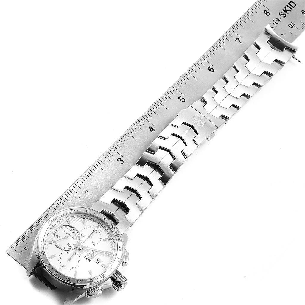 The Tag Heuer Link CJF211A.BA0594 Men's Stainless Steel Silver Dial CJF211A.BA0594 Men's Stainless Steel Silver Dial model watch is shown from a top-down angle, showcasing the face, crown, and metal bracelet alongside a ruler.