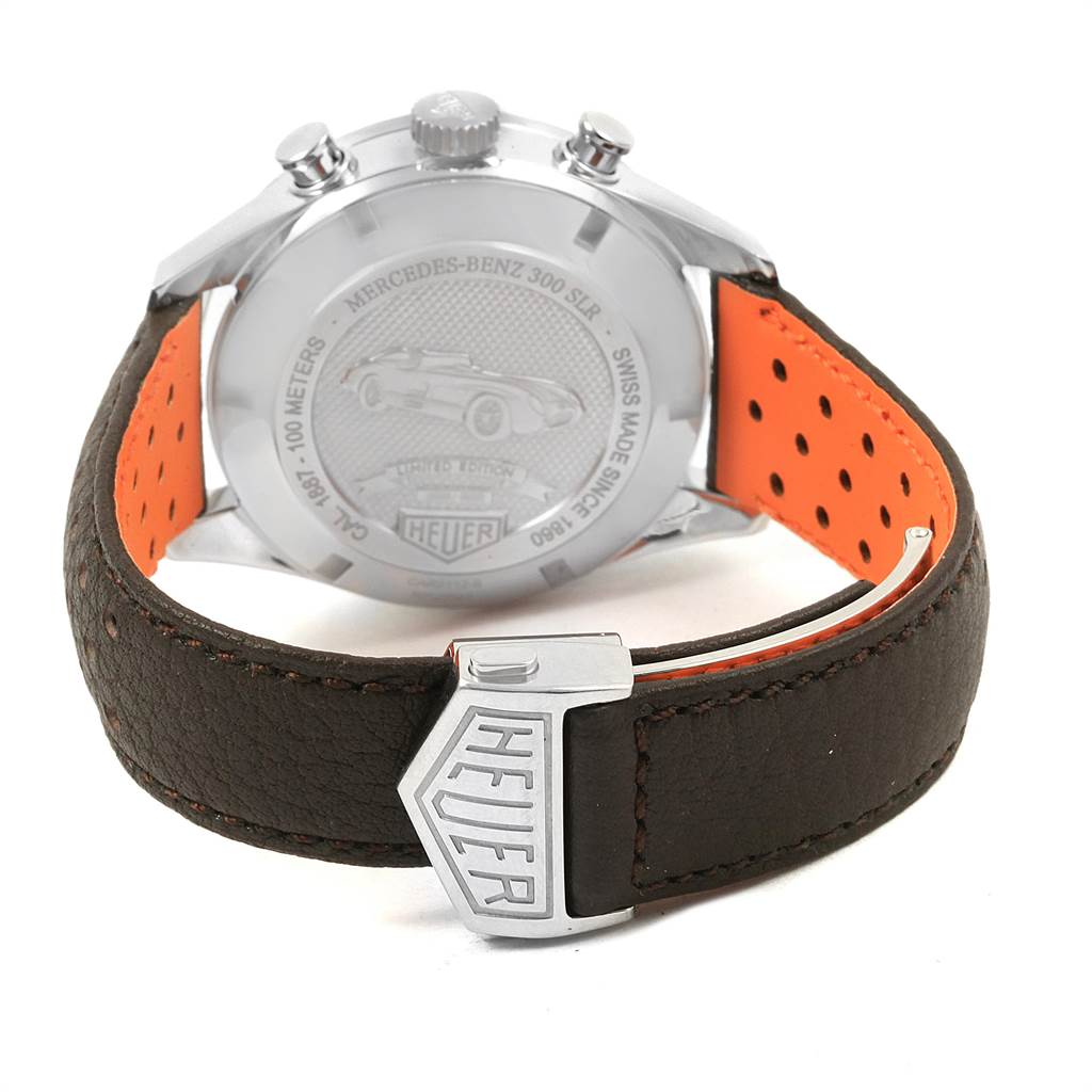 The image shows the back case and leather strap of the SLR model by Tag Heuer, displaying the clasp with the Heuer logo.