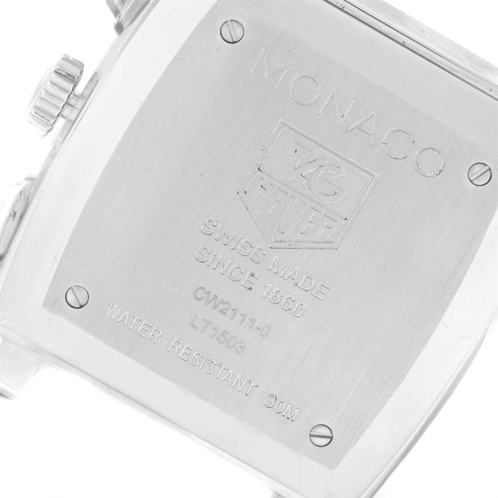 The image shows the back case of a Monaco model by Tag Heuer, highlighting the brand
s engraving and watch specifications.