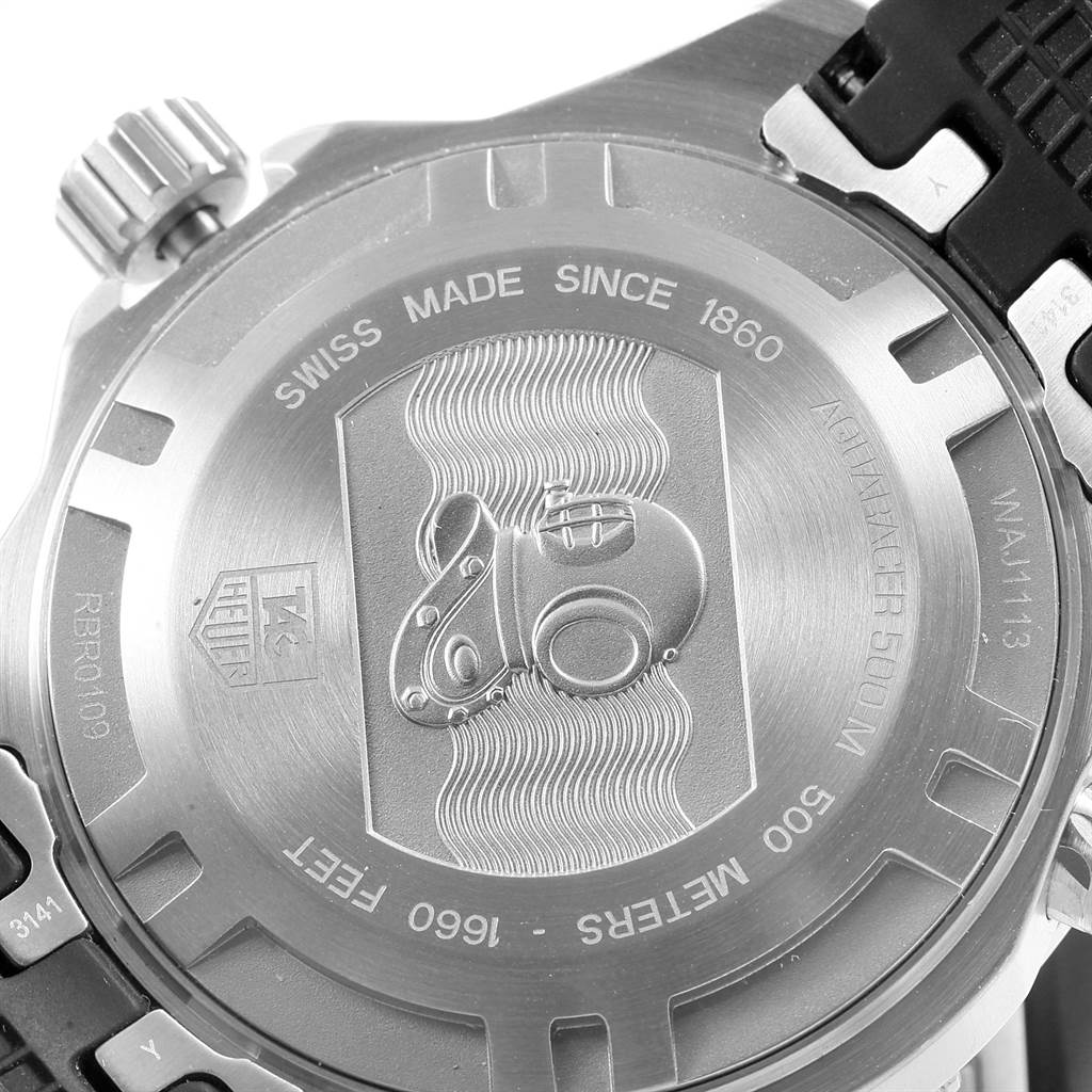 The image shows the back case of the Tag Heuer Aquaracer WAJ1113.FT6015 Men's Stainless Steel Orange Dial WAJ1113.FT6015 Men's Stainless Steel Orange Dial watch at a slight angle, highlighting the engraved details and crown.