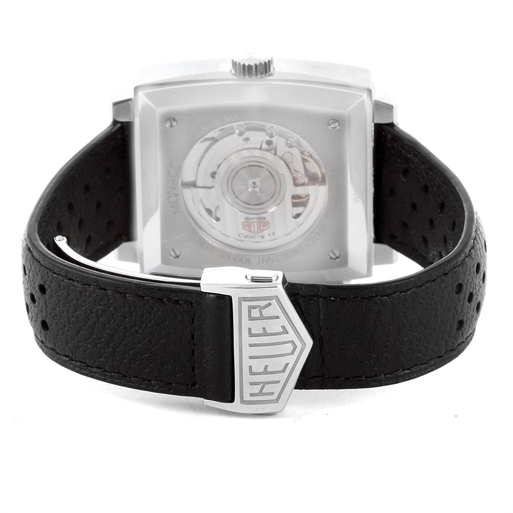 The image shows the back of the Tag Heuer Monaco CAW211P Men's Stainless Steel Blue Dial CAW211P Men's Stainless Steel Blue Dial watch, highlighting its transparent case back and black leather strap with a Heuer buckle.