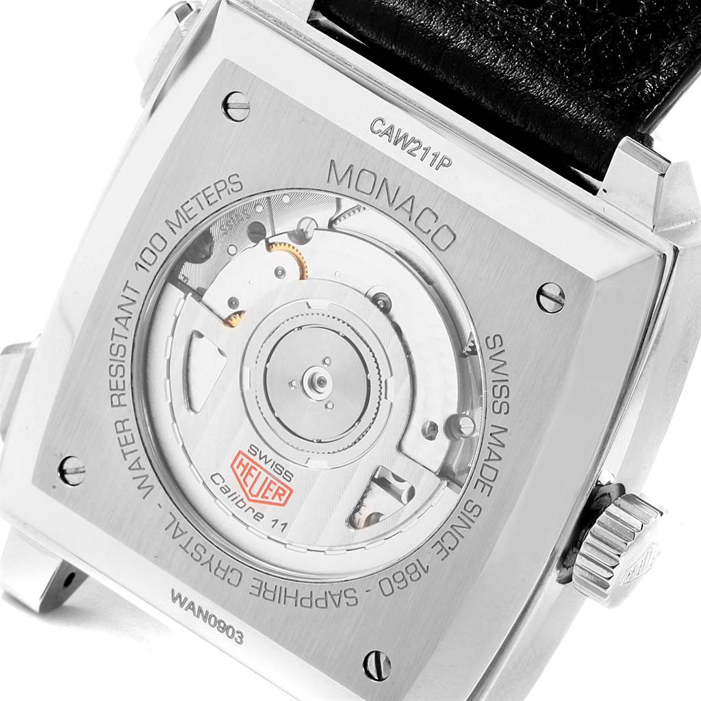 The image shows the back view of the Tag Heuer Monaco CAW211P Men's Stainless Steel Blue Dial CAW211P Men's Stainless Steel Blue Dial watch's case, displaying its inner mechanics and inscriptions.