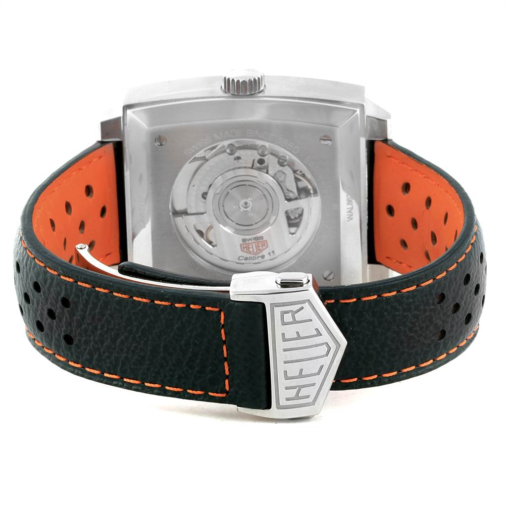 This image shows the back view of a Tag Heuer Monaco CAW211R.FC6401 Men's Stainless Steel Blue Dial CAW211R.FC6401 Men's Stainless Steel Blue Dial watch, highlighting its movement and leather strap with "Heuer" clasp.